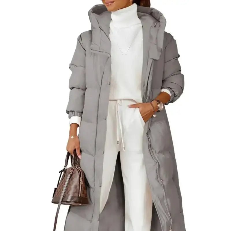 Parka longue femme kaki matelassée portée avec un outfit décontracté et un sac à main.